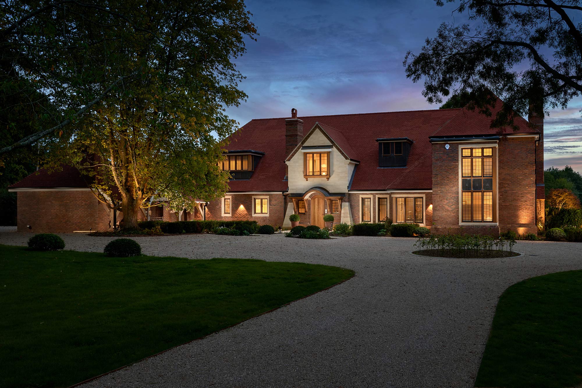 Exterior night front elevation of New Arts and Crafts House - built by KM Grant, Guildford, Surrey.